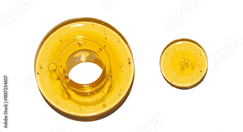 Two amber glass objects, possibly lenses or ornaments, displayed side by side on a neutral background from a direct overhead viewpoint