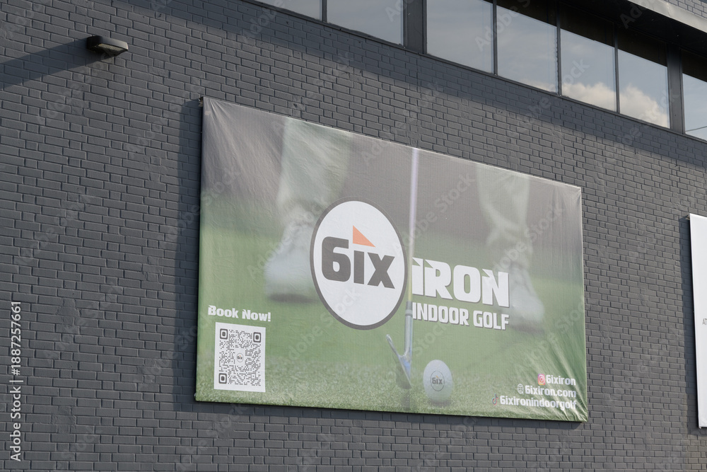 Obraz premium banner on an exterior wall for 6ix IRON, a premium indoor golf simulator facility in Toronto (either at 142 George St or 146 Dupont St)