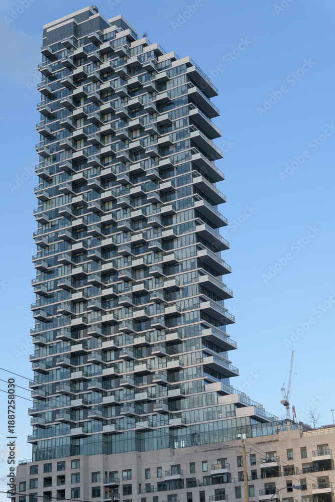 Fototapeta premium exterior of Monde Condominiums, a condominium complex, located at 12 Bonnycastle St (seen from Queens Quay E), Toronto