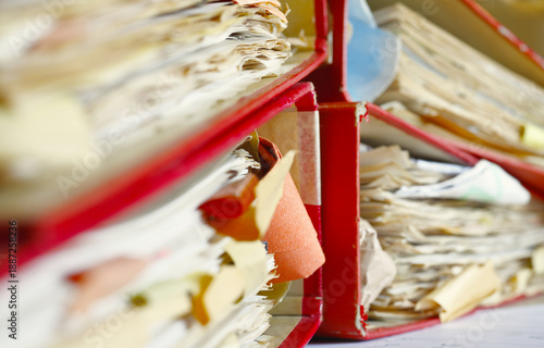 Stack of grungy messy ring binders,administrative barriers, bureaucratic obstacles, buraucracy,stress,overworked concept, Close up, shallow depth of field