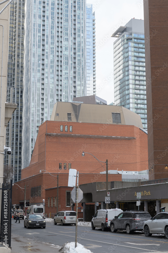 Fototapeta premium looking west on Asquith Av to the bulky brick building of Toronto Public Library - Toronto Reference Library, and towers in the Bloor Yorkville area