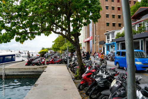 Wallpaper Mural Scooters parked along the waterfront in Fuvahmulah, Maldives during a busy day in Asia Torontodigital.ca