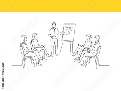 people sitting in chairs while a man presents on a flip chart