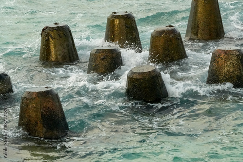 Wallpaper Mural Waves crash against concrete structures in Fuvahmulah, Maldives, highlighting the island's coastal features Torontodigital.ca