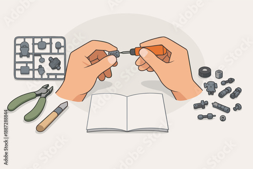 Male hands assembling model kit with tools and instructions on desk