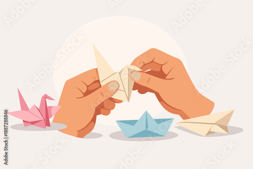 Hands folding origami with paper animals and shapes