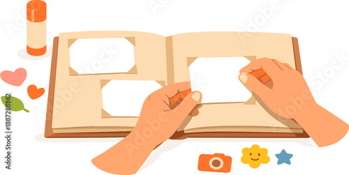 Hands arranging photos in album with scrapbooking elements