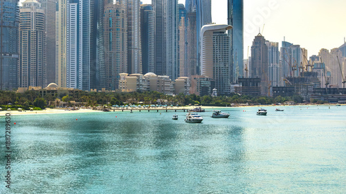 Dubai Marina skyline panorama with luxury yachts and beach at daytime