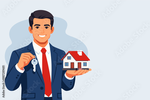 Young caucasian male realtor holding house model and keys in suit