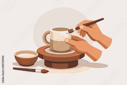 Hands painting ceramic mug on pottery wheel