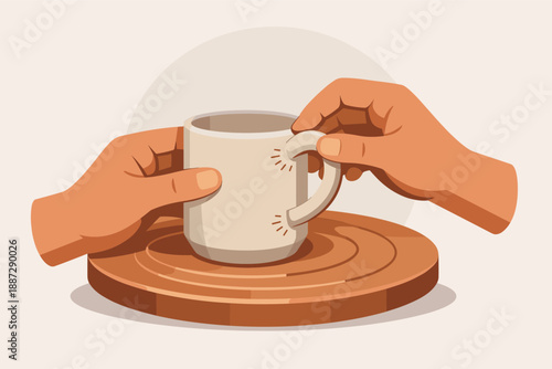 Hands holding a coffee cup on wooden surface