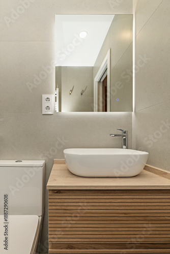 Wallpaper Mural large slabs of gray marble or travertine cover the walls and floor, while a freestanding bathtub with curved lines and a white quartz countertop basin provide contrast. Torontodigital.ca