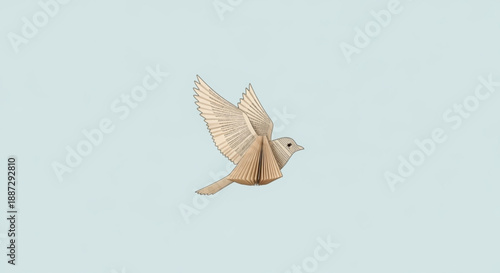 Origami bird in flight with spread wings on light blue background symbolizing freedom and creativity in a minimalist style