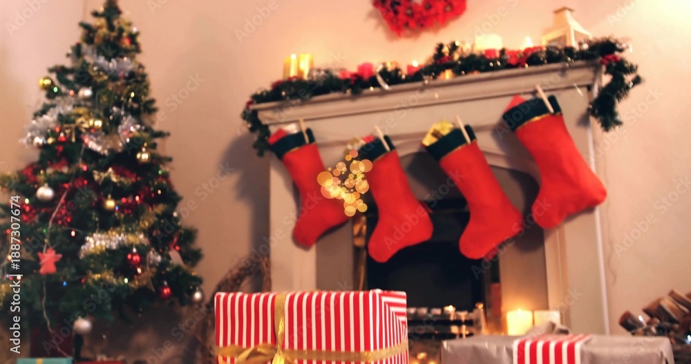 Obraz premium Displaying mantel draped with garland holding four red stockings at living room hearth, with gifts