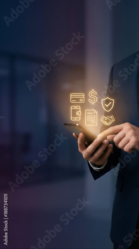 Man using a smartphone for secure online financial transactions, showcasing mobile banking convenience and digital wallet features with illuminated icons on a dark background