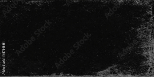 An abstract black and white grunge texture captures a dark starry night sky where cosmic dust and bright galaxy light blend into a snowy space atmosphere