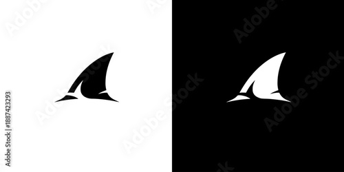 Black and white silhouette of a shark fin on a split color background
