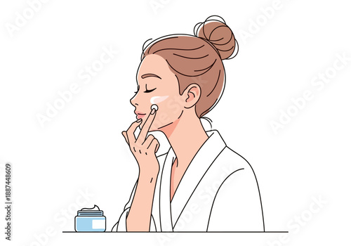 Woman Applying Cream to Face in Robe