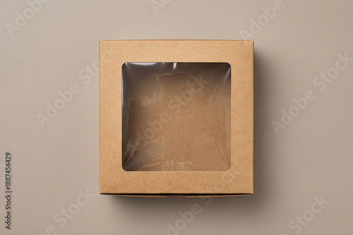 Top view of square brown cardboard cake box with clear plastic window on top