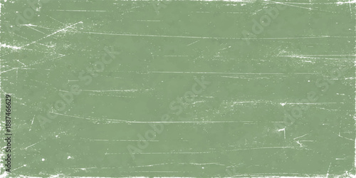 A blank vintage green grunge paper texture with a rough aged pattern and dirty chalk design creates an old textured wall backdrop on an empty canvas surface