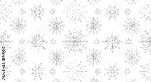 Sophisticated winter pattern showcasing many different light grey snowflakes of various designs on white background.