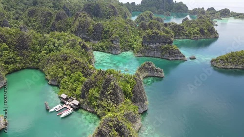 Raja Ampat, Indonesia: Aerial drone footage of the famous wayag viewpoint plateform overlooking a stunning lagoon in in Raja Ampat in west Papua in Indonesia.