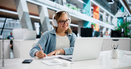 Focused Young Woman Taking Detailed Notes During Online Education Webinar