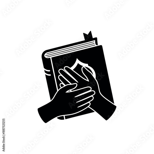 Hands holding a holy book with a bookmark.