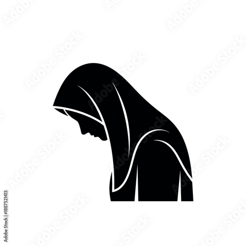 Silhouette of a woman in a hijab praying.