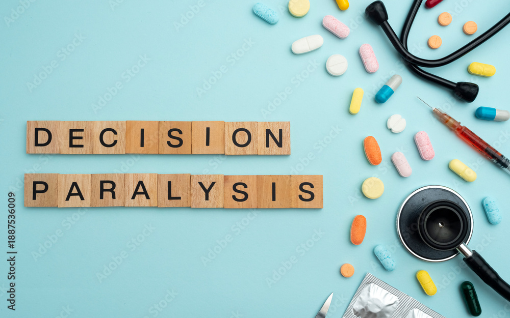 Fototapeta premium Decision Paralysis word on wooden blocks with prescription pills and stethoscope on sky blue background. Mental health disorder treatment concept, psychological care, therapy, 