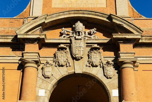 Ancient stone portal Porta Galliera stands majestic under a clear blue sky representing the rich historical heritage of Bologna city