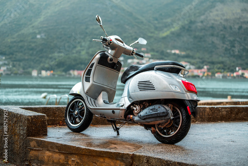 Tableau sur toile Silver moped by lakeside in countryside