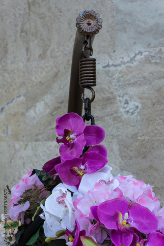 Detail from hanging chair decorated with artificial flowers