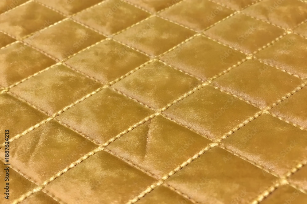 Fototapeta premium mustard yellow velvet quilted fabric texture with diamond stitching