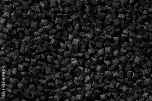 Tableau sur toile A top-down macro photo shows a dense, uniform layer of small, black, rectangular or cylindrical conductive polymer granules with a matte, textured surface