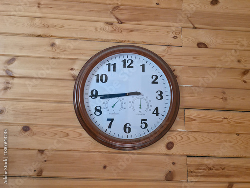 Wallpaper Mural Round clock with thermometer and hygrometer hanging on a wooden wall for indoor temperature and humidity monitoring application. Torontodigital.ca