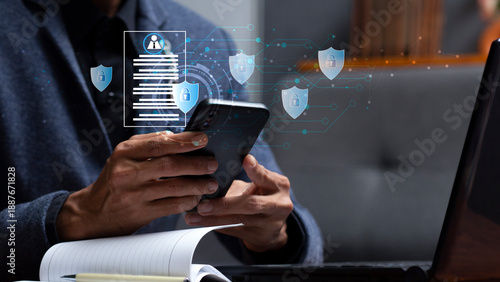 personal data security and man using mobile phone during work with laptop at workplace