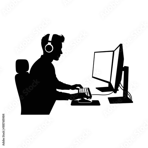 Man working on computer with headphones on.
