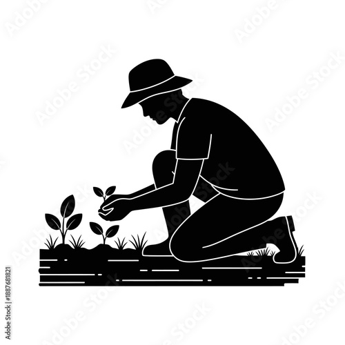 Man kneeling and planting a seedling in the garden.