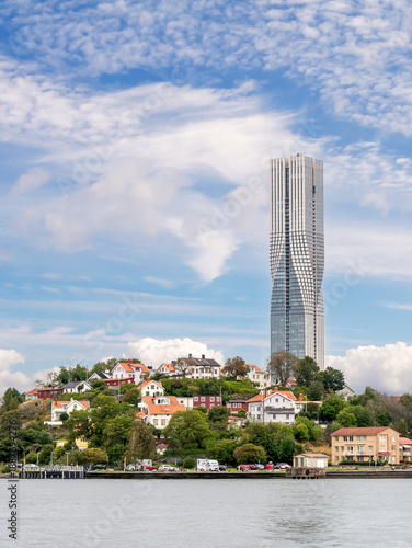 View from river towards Karlatornet residential tower rising on Slottsberget hill along Göta älv, Lindholmen, Gothenburg, Sweden