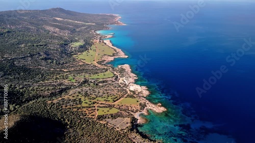 High-altitude drone view of the Akamas Peninsula coastline in Cyprus. Wide aerial landscape showing rugged shore, open sea and natural coastal formations. Ideal for travel, nature and scenic visuals.
