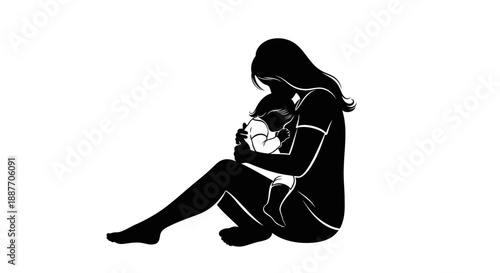 Mother holding her baby in a silhouette.