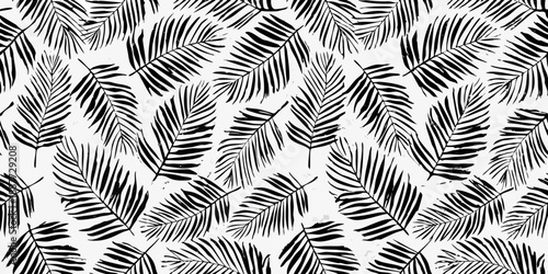A seamless tropical pattern featuring black and white palm leaves