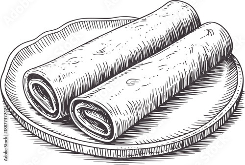 Two rolled crepes with dark filling a decorative plate dish