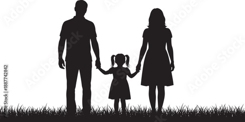 Black and white silhouette of a happy young family with father mother and small daughter holding hands while standing together in a grassy meadow.