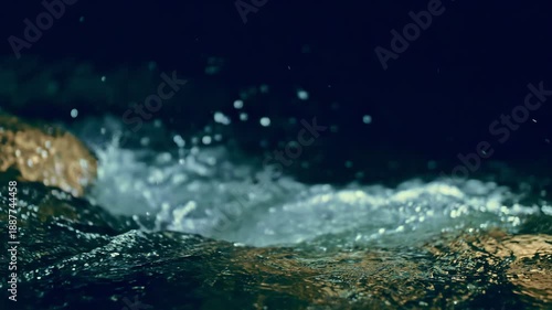 Slow motion ripple waves on dark water river.Super slow motion detail 4k video.Amazing dramatic night cinematic backgrounds.Epic mystical magic night view.Crystal clear spring river.Underwater stones