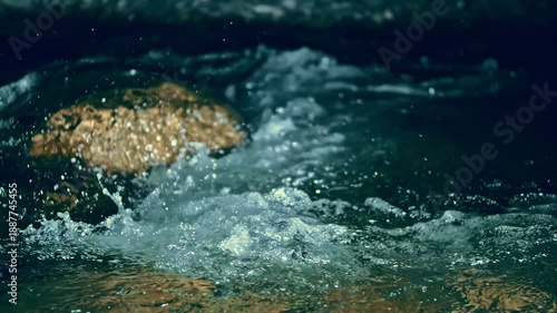 Slow motion ripple waves on dark water river.Super slow motion detail 4k video.Epic mystical magic night view.Amazing dramatic night cinematic backgrounds.Underwater stones.Crystal clear spring river