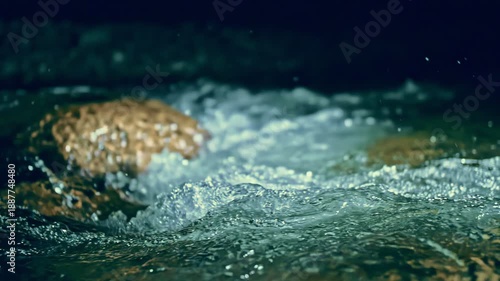 Slow motion ripple waves on dark water river.Epic mystical magic night view.Amazing dramatic night cinematic backgrounds.Super slow motion detail 4k video.Underwater stones.Crystal clear spring river