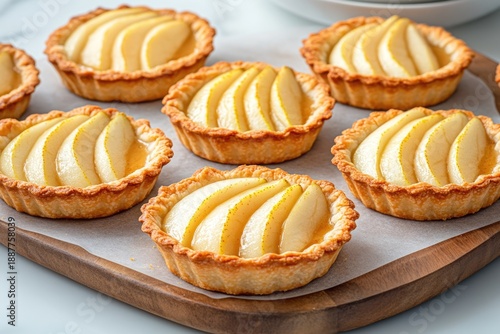 Wallpaper Mural Warm pear tarts with almond crumble on a rustic wooden board Torontodigital.ca