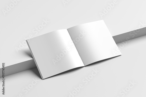 A square mockup of a magazine, brochure, or book with blank pages and realistic perspective shadows resting on a tiered background.